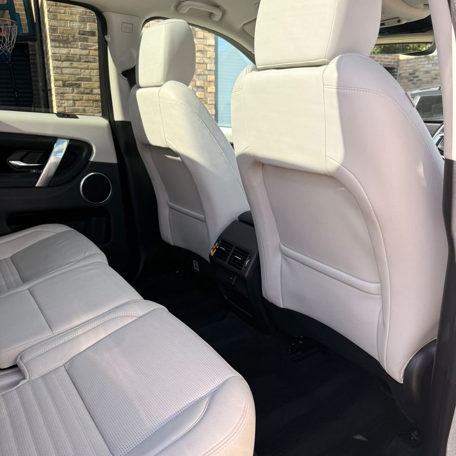 Clean white leather rear seats in a Land Rover