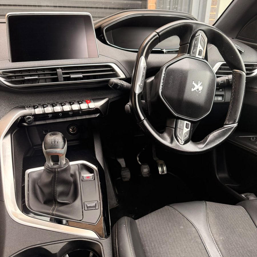 A cleaned centre console, gear knob and steering wheel in a Peugeot