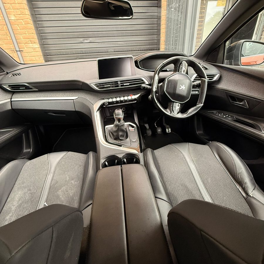 The cleaned dashboard and front seats of a Peugeot SUV