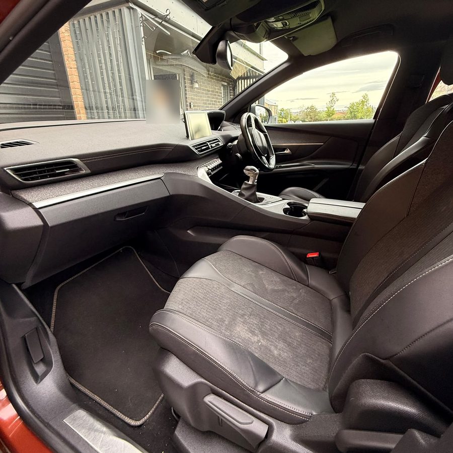 The front passenger seat and footwell of a Peugeot after an interior clean